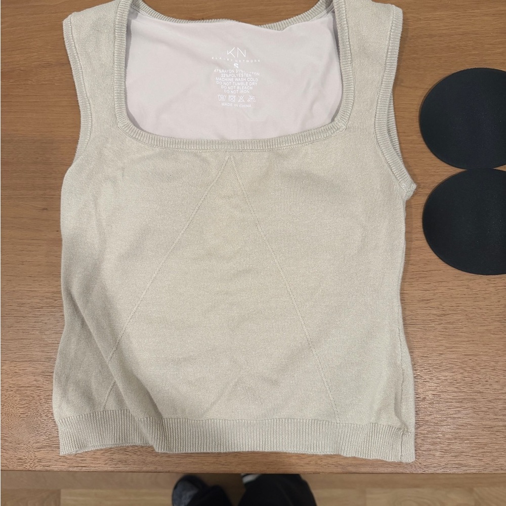 A pair of Klassy tank tops with built in bras and extra cups.